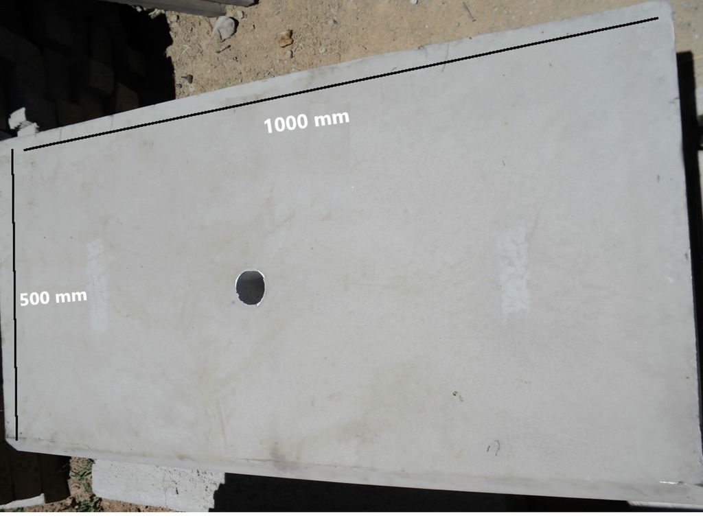 A small, heavy-duty concrete catchpit cover for stormwater drains.
