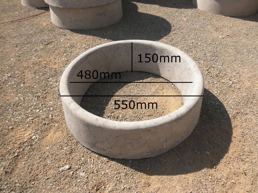 A round concrete tree ring for landscaping and garden beds.