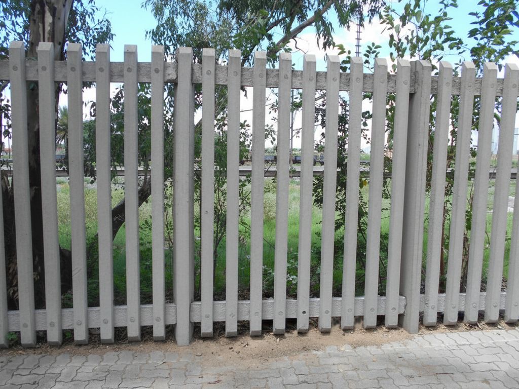 An installation of heavy-duty concrete palisade fencing providing high security for a property.
