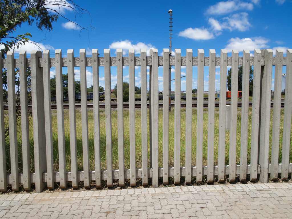 A high-security concrete palisade fence providing a strong perimeter.