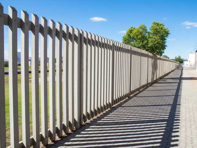 Industrial-grade concrete palisade fence.